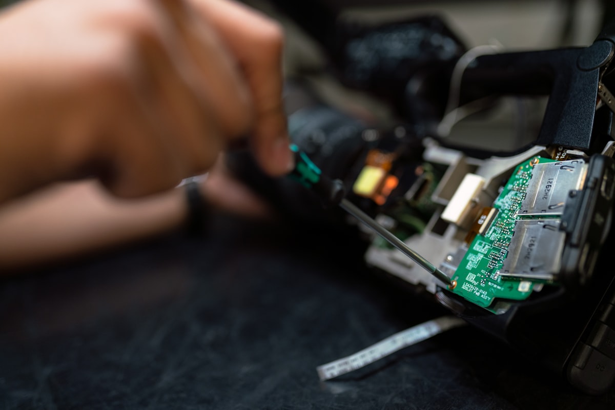 A technician inspecting an appliance control board during a diagnostic service call
