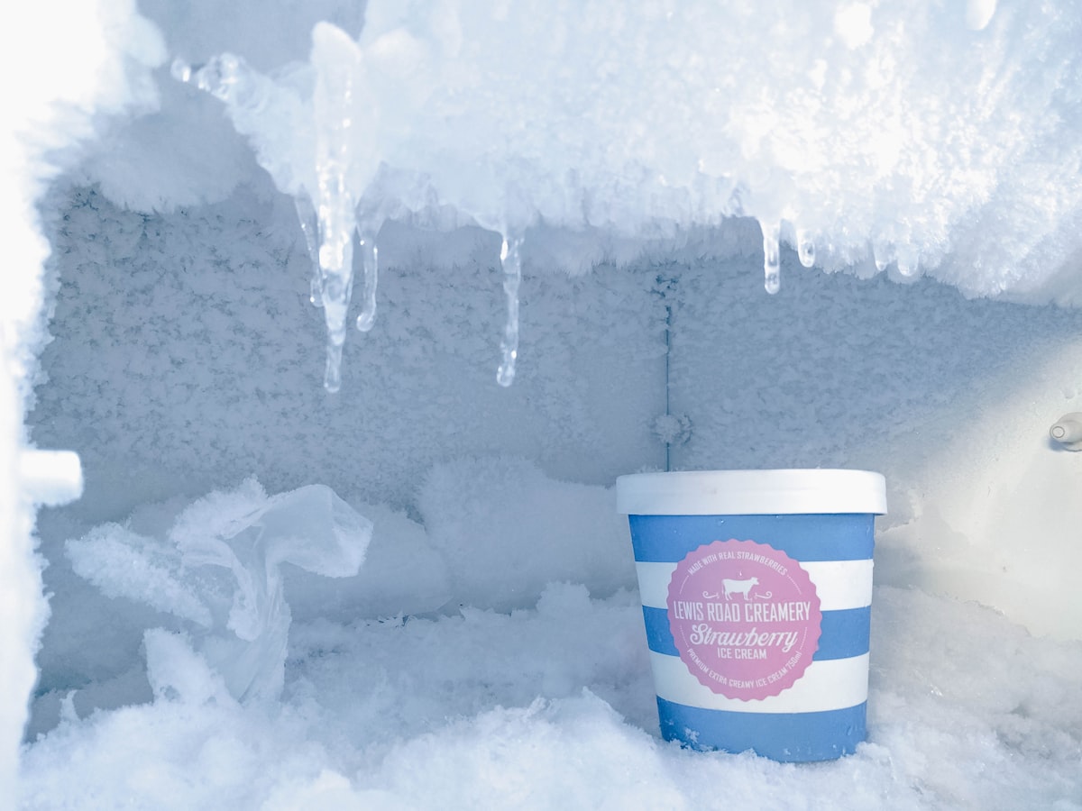 Heavy frost and ice build-up inside a freezer signaling a defrost system problem