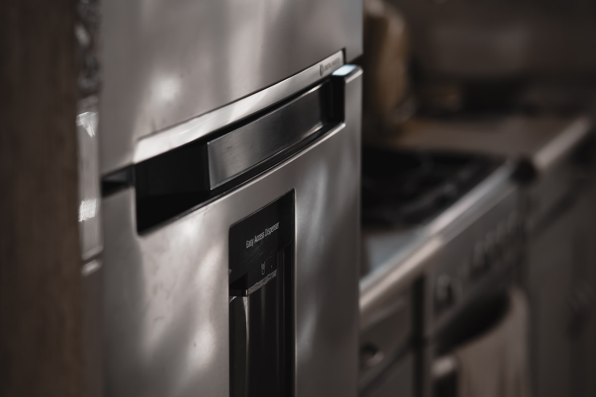 A premium stainless steel built-in refrigerator integrated into custom cabinetry in a luxury Fisher Island kitchen