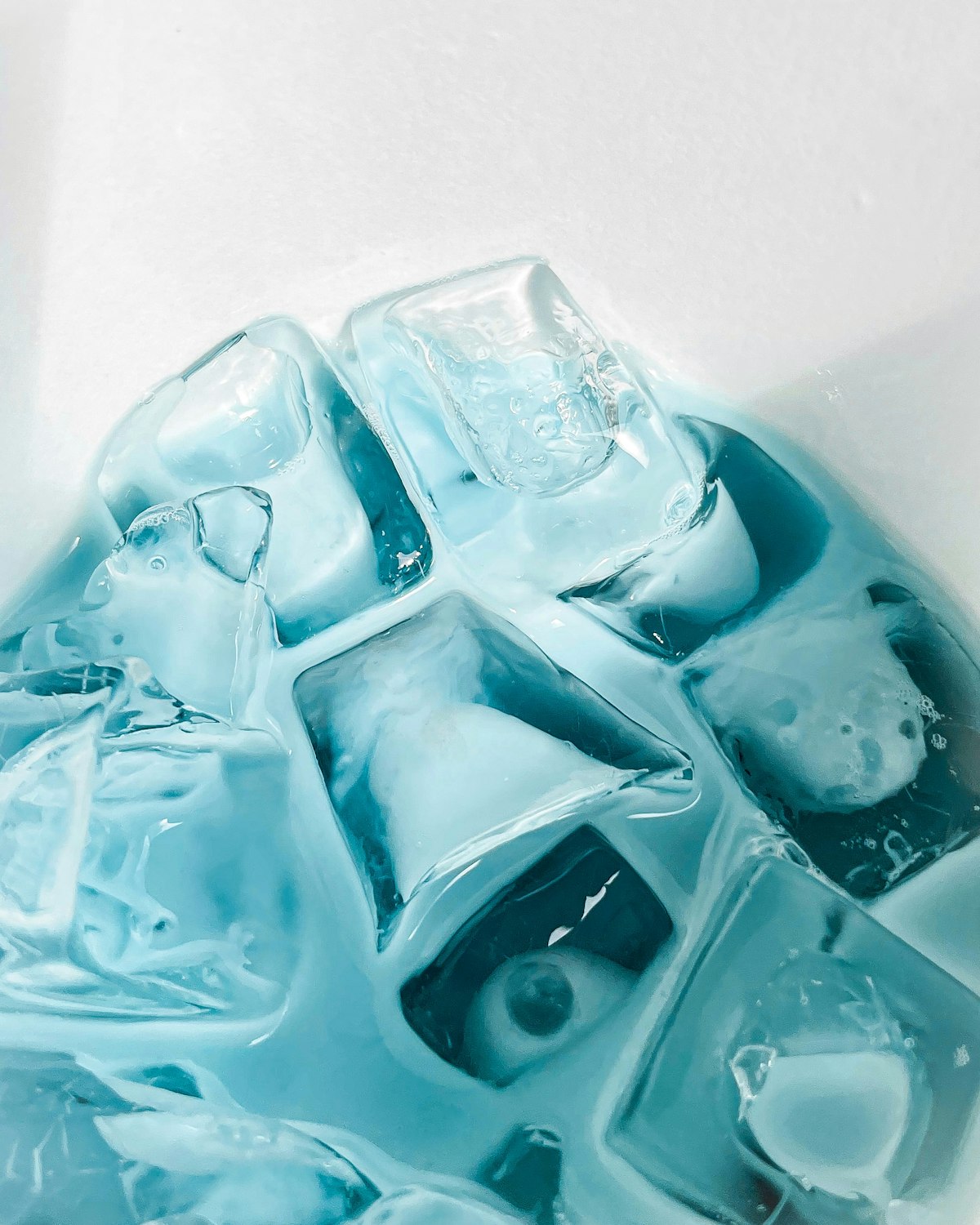 A close-up of clear, fully formed ice cubes showing the size and clarity a properly working Golden Beach ice machine should produce