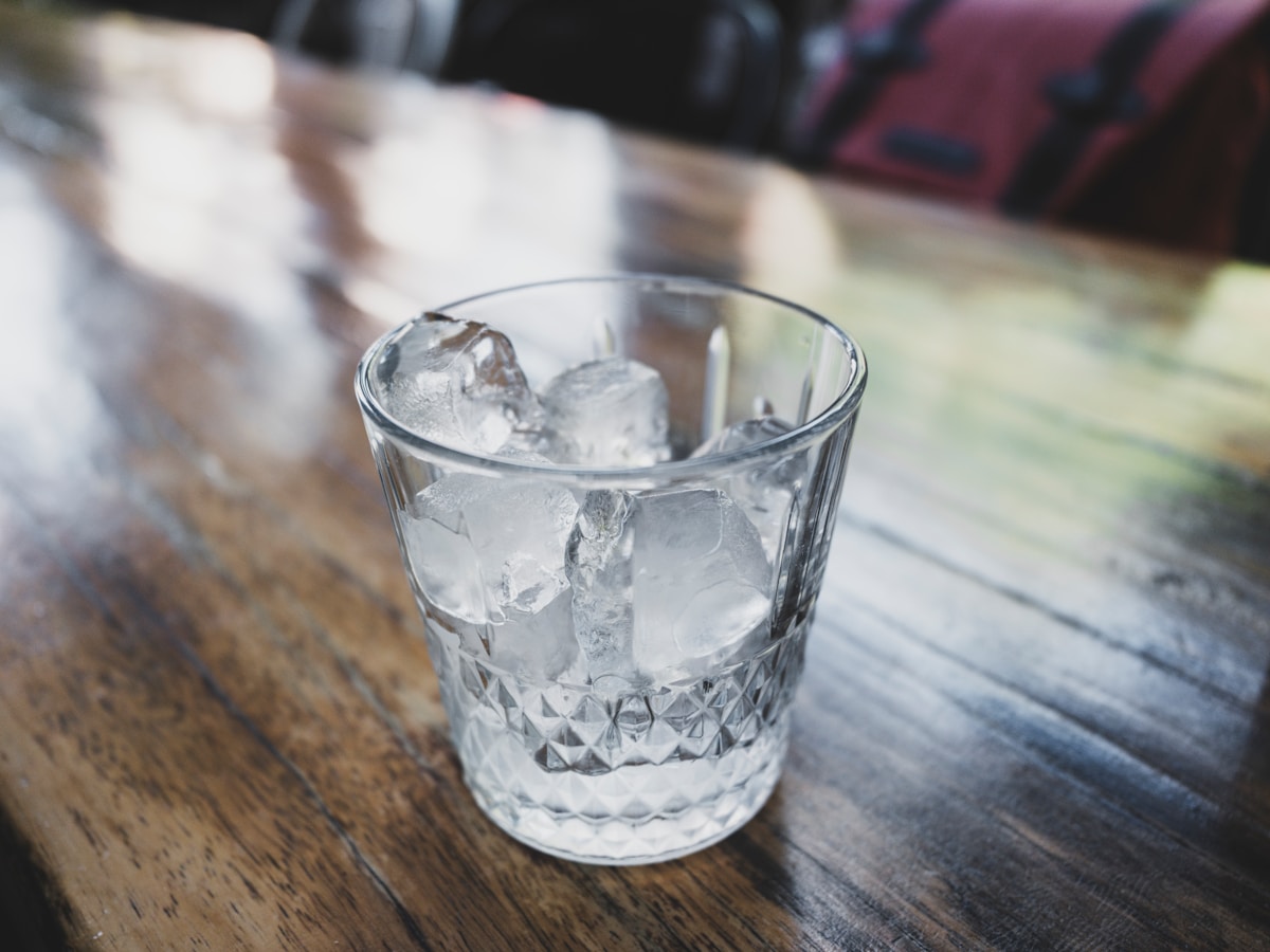 A glass filled with clean, clear ice cubes produced by a well-maintained ice maker with a fresh water filter