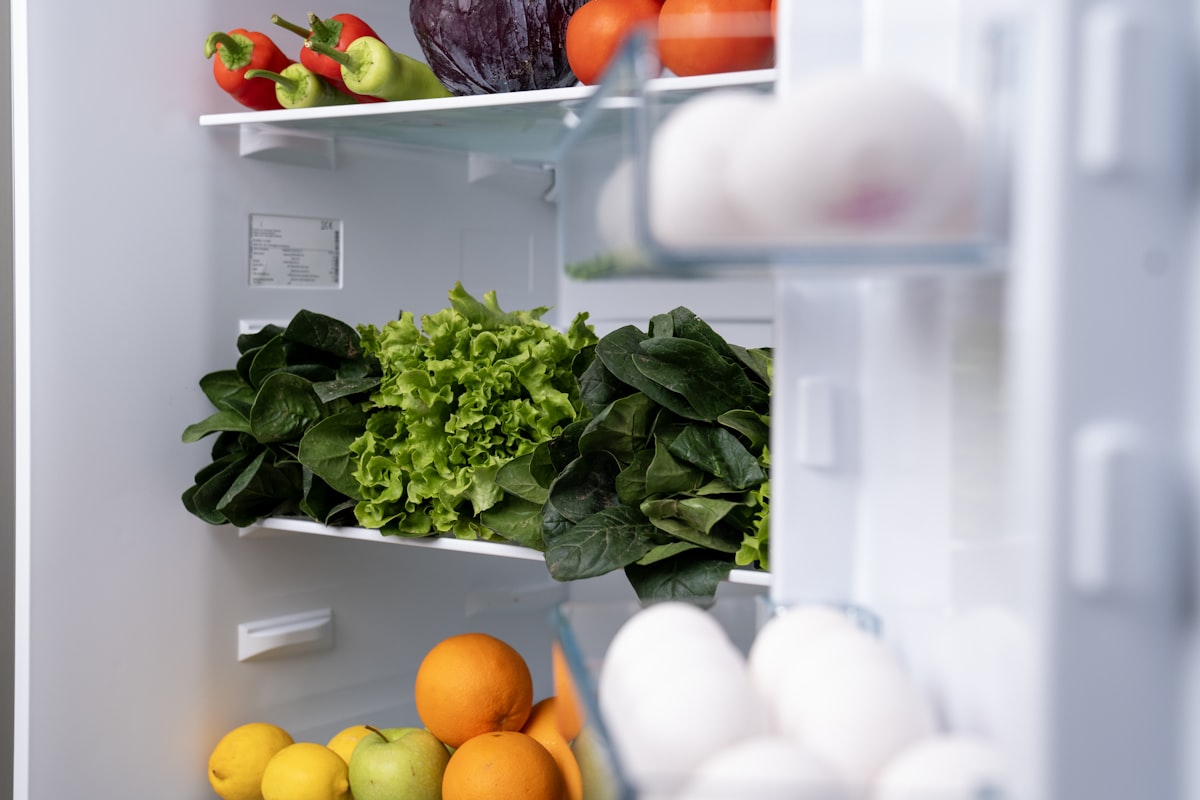 A refrigerator interior stocked with fresh fruits and vegetables that must stay below 40 degrees in a Fisher Island residence