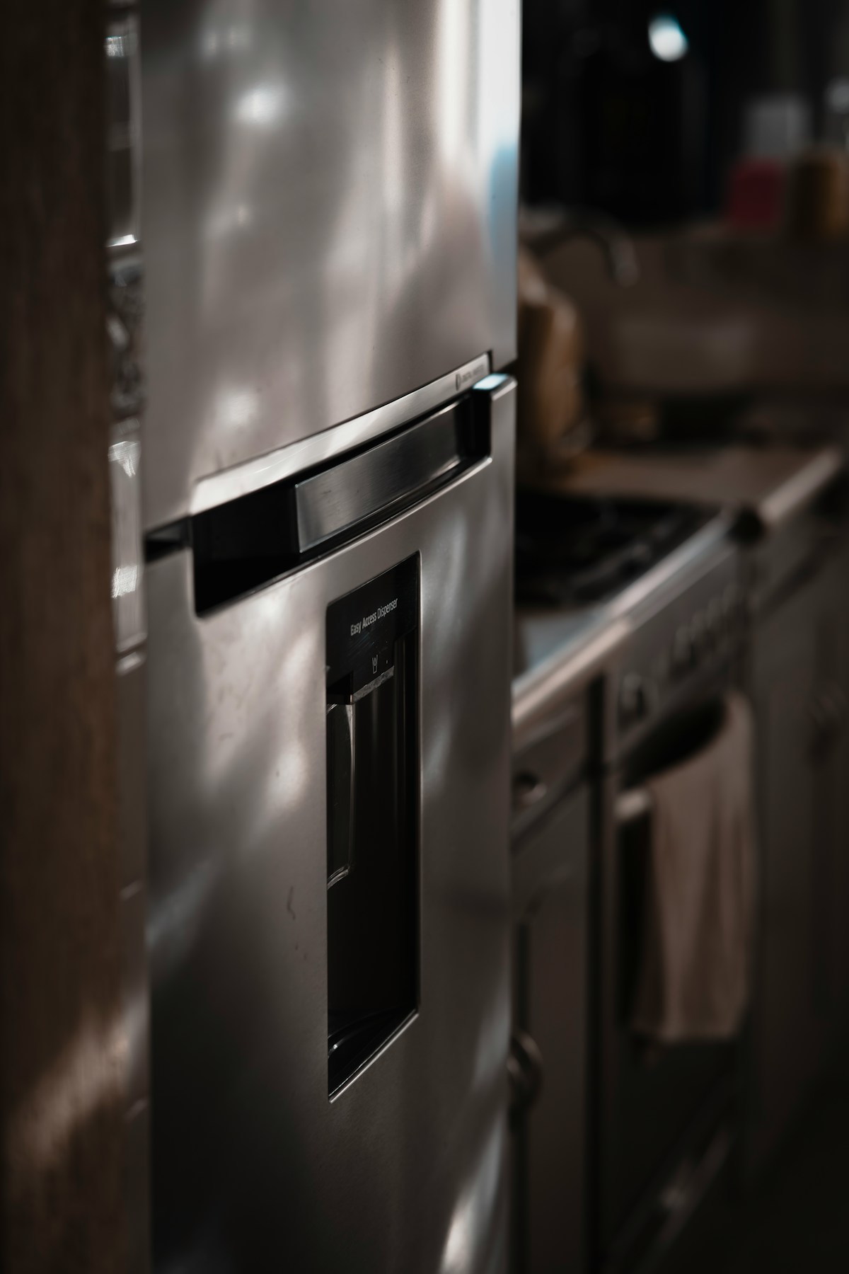 A stainless steel refrigerator with a water dispenser standing in a Doral kitchen