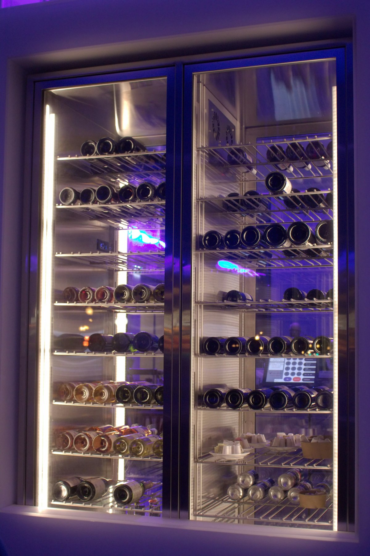 A built-in dual-zone wine cooler stocked with bottles in a Bay Harbor Islands luxury home