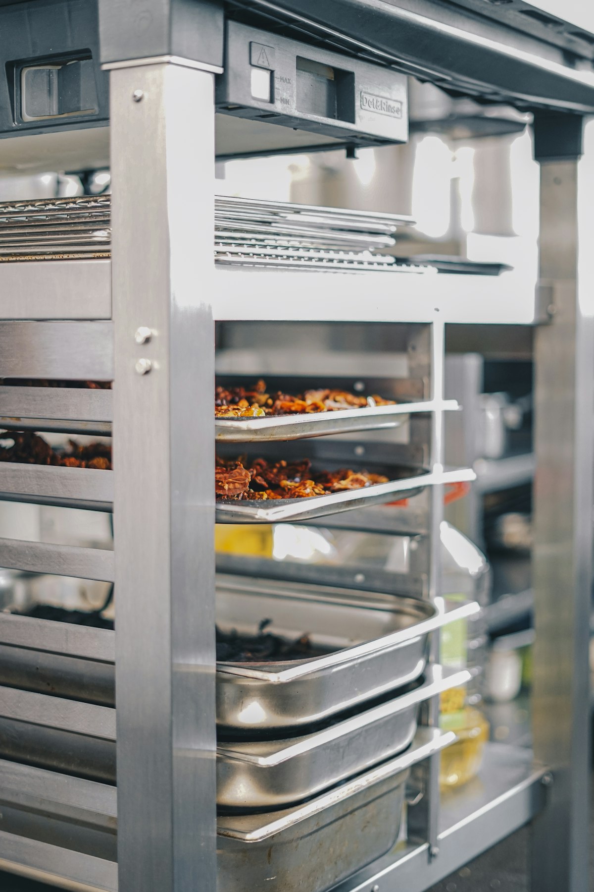 A professional oven cavity with trays of food inside, showing the even heat a correctly calibrated oven delivers